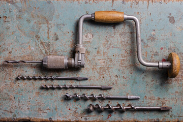 Rotterdam, Netherlands - 11-11-2022: Vintage brace or hand drill with extra drills flat lay