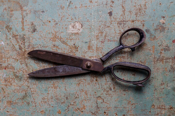 Vintage black metal scissors flat lay on a rustic background