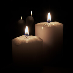 Two candles reflect