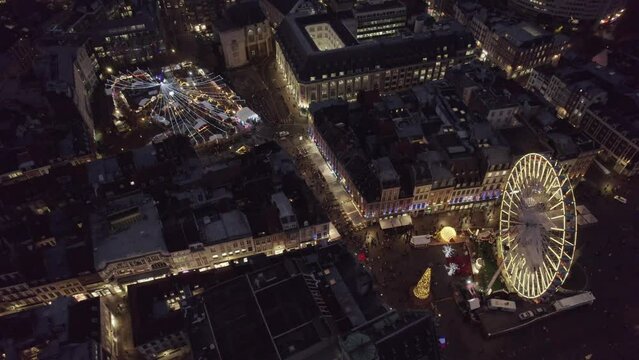 Aerial drone view of Lille, France, at Christmas by night. Amazing 4K video motion of Christmas Market and Wheel
