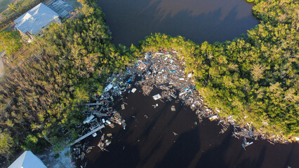Piles of debris sit in the water of Estero Bay following Hurricane Ian. 