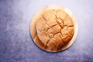 Freshly baked bread in black background, top view