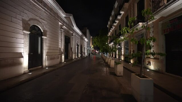 Pushing in on night time street scene with blocked off roads for restaurant eating dining with festive lights across the Santiago Cathedral.