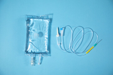 Fototapeta na wymiar Infusion bag in the blue background. IV drip chamber