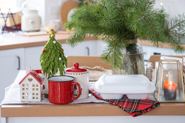 Food delivery service containers on table in white kitchen, festively served for celebration of Christmas and new year.  Saving time, hot order, disposable plastic box, craft package. mock up