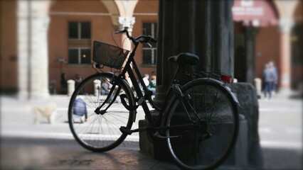 Fototapeta na wymiar Bicycle with basket standing on old city street in European city