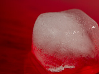 Ice cubes on a red background. Ice on red.