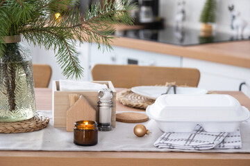 Food delivery service containers on table in white kitchen, festively served for celebration of Christmas and new year.  Saving time, hot order, disposable plastic box, craft package. mock up