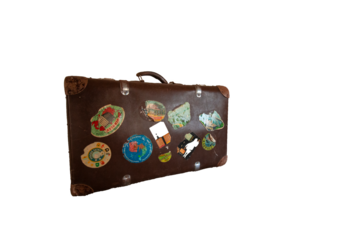 old brown suitcase with stickers from the ddr - german democratic republic - with stickers on transparent background