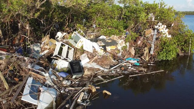 Debris from Hurricane Ian litters the waters of Fish Trap Bay on Bonita Beach, FL