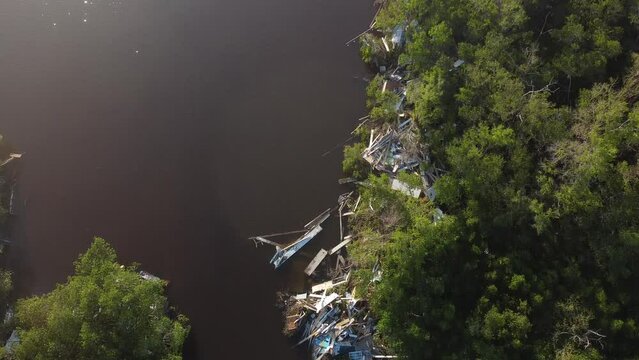 Debris from Hurricane Ian litters the waters of Fish Trap Bay on Bonita Beach, FL