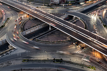 Fototapeta na wymiar Expressway top view, Road traffic an important infrastructure, Drone aerial view fly in circle, traffic transportation, Public transport or commuter city life concept of economic and energ, transport.
