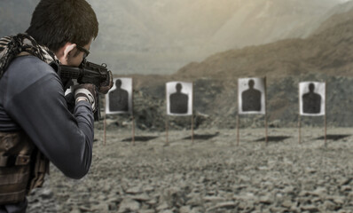 Man soldier military aiming and shooting assault rifle at shooting range
