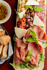 Charcuterie Board. Cheese Board Assortment on cured and salted deli meats and cheeses, pastrami, salami, prosciutto served with olives and dried fruits. Classic traditional party favorite.  