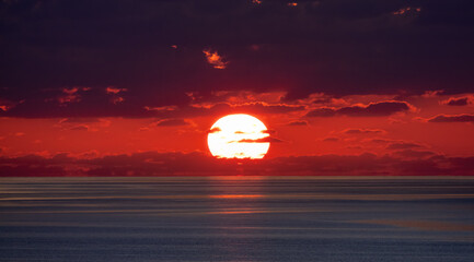 Fototapeta na wymiar Dramatic Colorful Sunrise Sky over Mediterranean Sea. Abstract Red Sky. Cloudscape Nature Background.