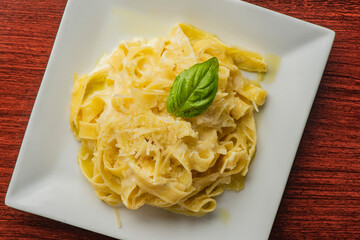 Spaghetti carbonara. Pasta with cured pork, cheese, egg, bacon, pepper and Italian parsley. Classic American or Italian restaurant favorite. Homemade pasta with butter sauce, meat and cheese.