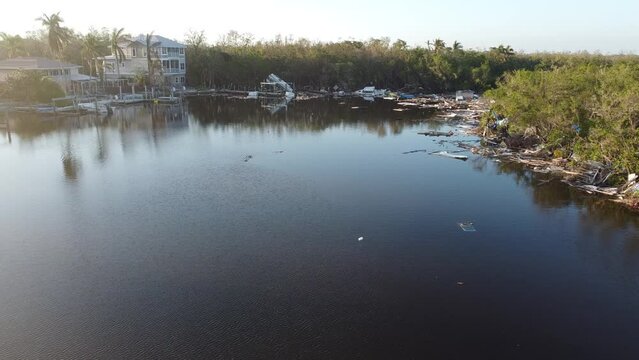 Debris from Hurricane Ian litters the waters of Fish Trap Bay on Bonita Beach, FL