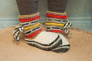 feet shod in warm winter knitted socks slippers cold heating season crisis