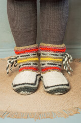 feet shod in warm winter knitted socks slippers cold heating season crisis