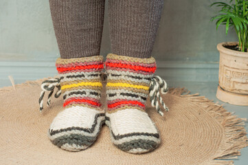 feet shod in warm winter knitted socks slippers cold heating season crisis