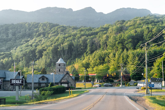 Banner Elk, USA - July 6, 2021: Downtown Banner Elk road street highway in North Carolina city town with stores shops bank and view of Grandfather mountain silhouette ridge ridgeline