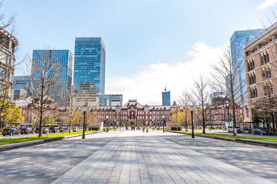 Tokyo, Japan - March 31, 2019: Famous Tokyo Station building exterior facade historic entrance view in downtown Chiyoda city with skyscrapers modern cityscape skyline road street