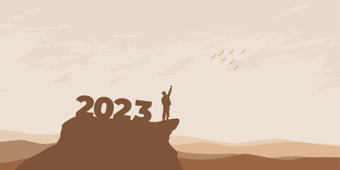 New Year 2023 concept. Man meets dawn in mountains for new year 2023. New Start motivation inspirational quote message on silhouette man