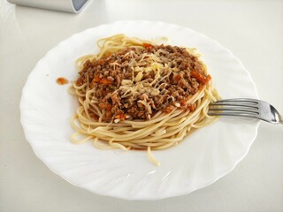 Pasta with minced meat and cheese on the table