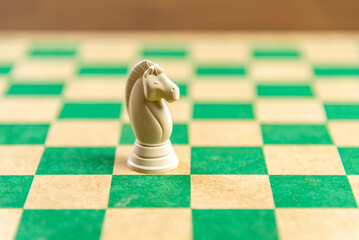 Chess game pieces on the green board
