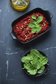 Black Serving Pan With Caviar Made Of Beetroot And Other Vegetables On A Black Marble Background, High Angle View, Vertical Shot