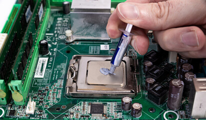 Engineer repairman holding hands in black gloves chip processor, CPU to insert into the socket of the computer motherboard. The concept of technology hardware in the neon light