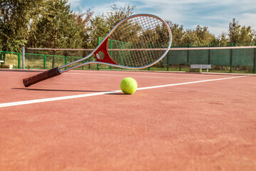 Tennis ball and racket on the court