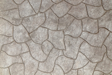 Rough cement plaster imitating stones on the wall close-up. High resolution photo.