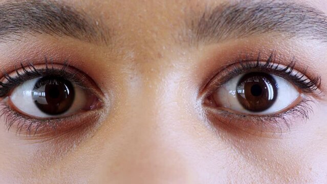 Surprise, vision and closeup of eyes with shock, omg or wow expression with mascara or eye shadow. Crazy, focus and zoom of a shocked woman with big brown iris with natural makeup or cosmetics.