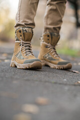 Leather waterproof boots on military. Demi-season high boots of khaki color