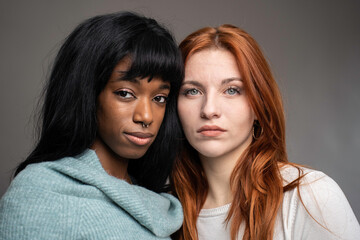 Couple of young women of different ethnicities - Red headed Caucasian woman with African female...