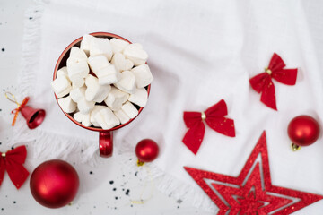 Fototapeta na wymiar Christmas holiday greeting card red mug with marshmallows