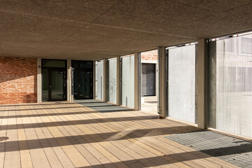 An inside view of an empty room of a residential building illuminated with sunlight