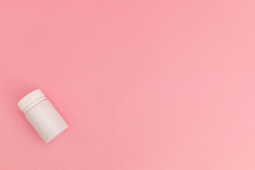 Medicine with pills on pink background