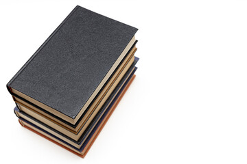 a stack of old books lies on the table.