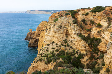Fototapeta na wymiar Dramatic view of a rugged Atlantic ocean coastline in Portugal Algarve Region