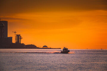 Fototapeta premium coast guard boat at sea at sunset view from the shore