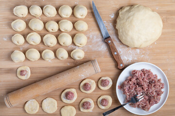 The process of making homemade dumplings. Minced meat on the dough. Russian food