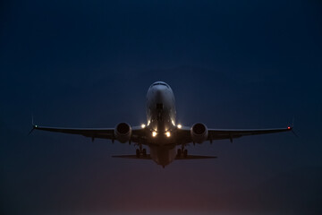 passenger plane takes off at night, airfield lights
