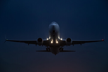 passenger plane takes off at night, airfield lights