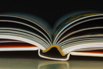 Opened hardcover book on table close-up