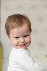 the little boy purses his lips ridiculously. portrait of a beautiful blue-eyed child.