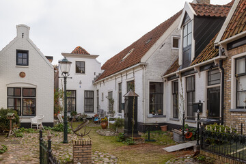 Fototapeta na wymiar Courtyard with water pump in the center of the village of Den Burg on Texel.