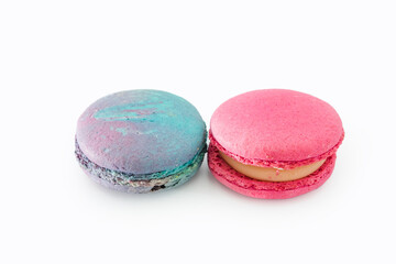 Sweet colorful macarons isolated on white background. Tasty colourful macaroons. Two multi-colored blue and pink macaroons. French pastry made from egg whites.
