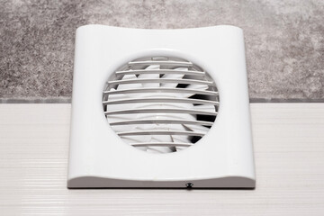 The fan is built into the wall in the bathroom, toilet or kitchen